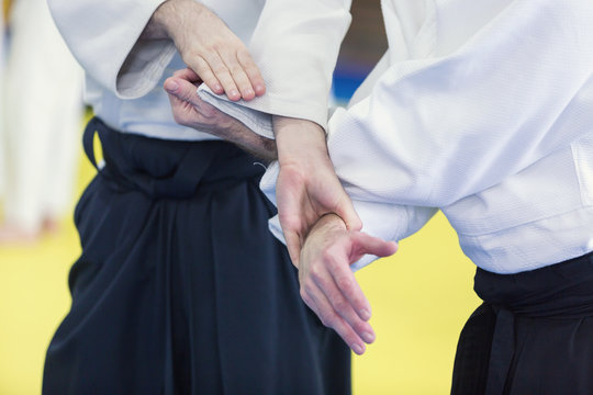 Two people practice Aikido on martial arts training