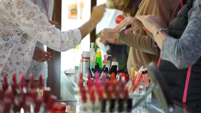 Female customers testing new beauty products in department store, cosmetology