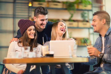 Group of young people sitting in a coffee shop having fun