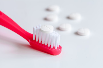 concept toothache with toothbrush and pills at white background