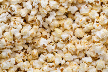 Popcorn background. Caramel sweet corn. Cinema snack.