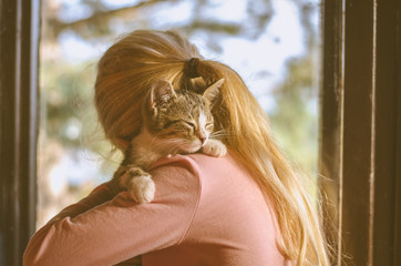 child hugging a cat