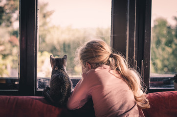 child hugging a cat © katarinagondova