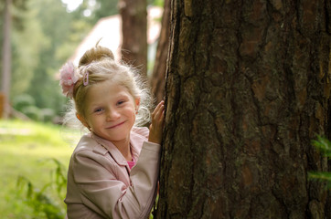 beautiful blond girl and tree trunk