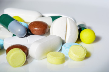 Tablets of different shapes, sizes and colors, close-up