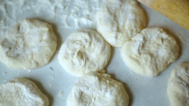 Preparation of belyashes. Traditional russian meat pies belyashi. belyashes on a table. Russian, Bashkir and Tatar cuisine.