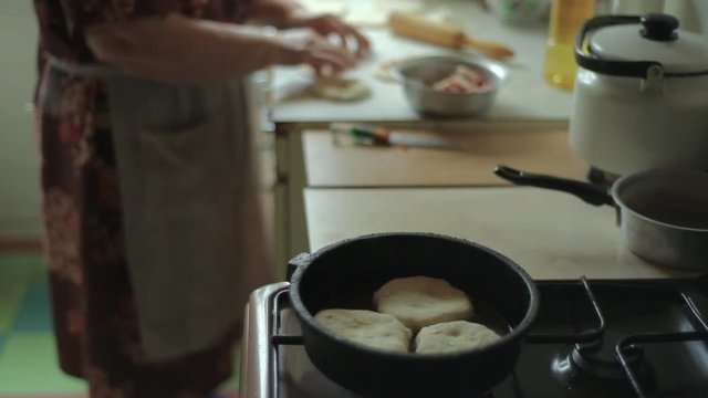 Preparation of belyashes. Traditional russian meat pies belyashi. belyashes on a table. Russian, Bashkir and Tatar cuisine.