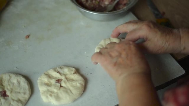 Preparation of belyashes. Traditional russian meat pies belyashi. belyashes on a table. Russian, Bashkir and Tatar cuisine.
