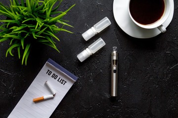 concept of electronic cigarette on dark background top view