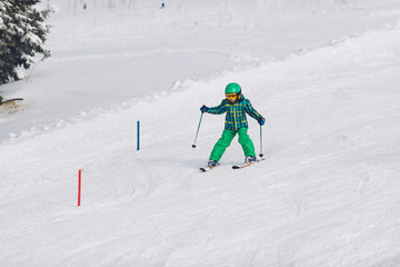 Little boy skiing down the hill