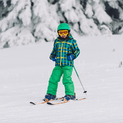 Portrait of little boy skiing