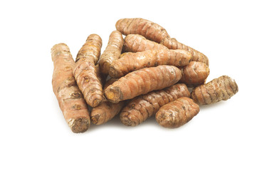 turmeric root and some slices on a white background