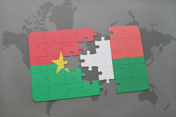 puzzle with the national flag of burkina faso and madagascar on a world map