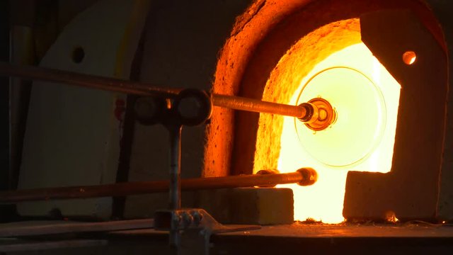 Glassblower Puts a Statuette Pedestal Into Flame Glassblowing Furnace Festival of High Temperatures People Demonstrating Skills Making Glass Decoration