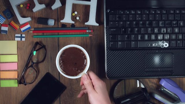 4k Technology Composition from Above of Hand Grabbing Coffee