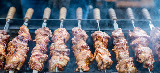 delicious meat on skewers cooked on fire