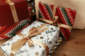 Christmas presents wrapped in colorful gift boxes and golden rib