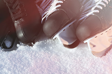 black hockey skates and for figure skating. snow, bright sun