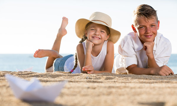 Two Kids Lying Beach