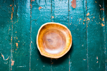 Fototapeta na wymiar The brown wooden plate on a rustic table closeup. horizontal top view.