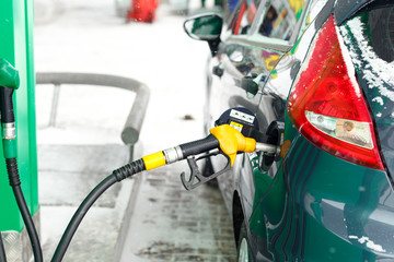 Car refueling on a petrol station in winter