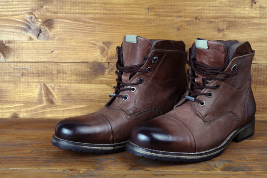 Brown Leather Winter Mens High Boots, Shoes On Vintage Wooden Background