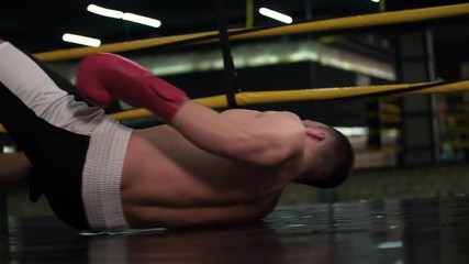 Boxer falling down to boxing ring floor after knockout punch HD slow motion video. Knock out fainting fighter in flight - Powered by Adobe