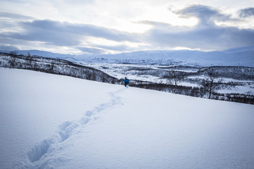 Snowy mountain lanscape with a child walking, Nordland, Norway