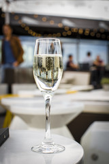 Glass of champagne on a lounge bar table