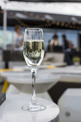 Glass of champagne on a lounge bar table