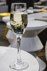Glass of champagne on a lounge bar table