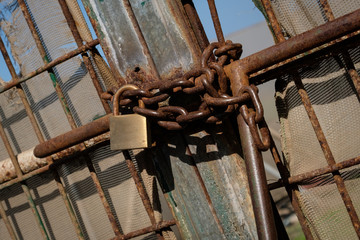 metal gate locked with chain and padlock