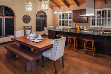 Amazing decorated wooden Kitchen with dark wood cabinets and island in Mediterranean style at night.