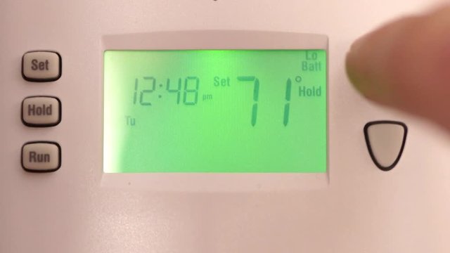 Digital thermostat used for heating and cooling - Energy expense and finance concept