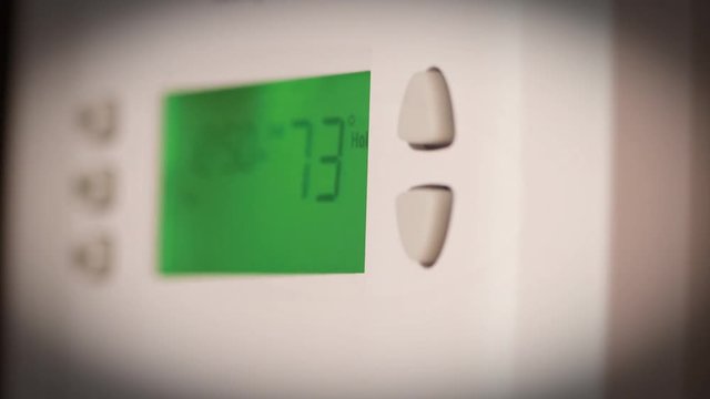 Digital thermostat used for heating and cooling - Energy expense and finance concept