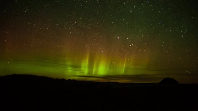 Timelapse of aurora and stars over the prairie at night in Montana