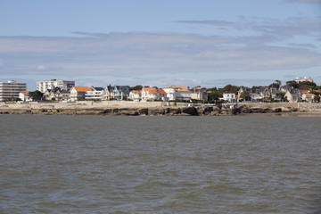 Fototapeta na wymiar View of the coastline with seaside resort of Royan with grey tourmented sky, France