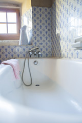 Vintage bathroom with blue tiles and enamel ewer