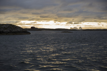 Fototapeta na wymiar Norwegian landscape, view of the Traena and Sana islands under midnight sun, Norway