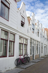 Fototapeta na wymiar Typicall Dutch cobble stone street with gabble houses aligned, Zierikzee, the Netherlands