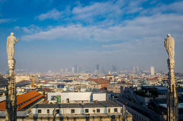 Statues overseeing Milan hazy skyline