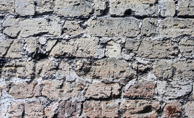 Old wall of scratched bricks
