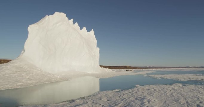 Glacier in reflection of meltwater pool on sea ice