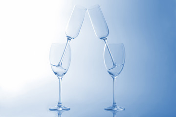 four empty wine glass on a light blue background
