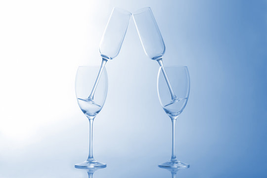 four empty wine glass on a light blue background