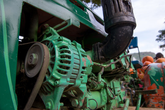 Close-up detail of a green tractor engine. Agricultural vehicles and industry concept.