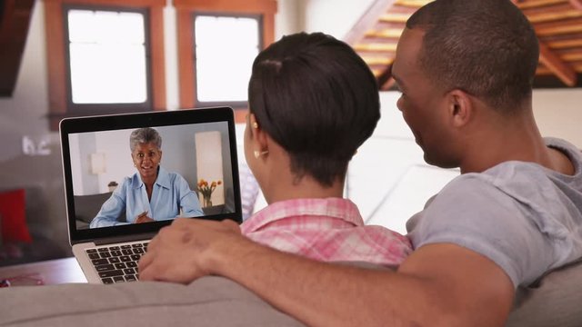 An African American couple video chat with his mother