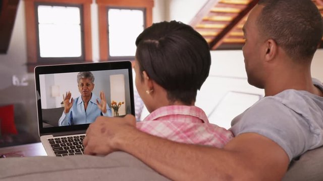 A black couple video chat with an older black woman