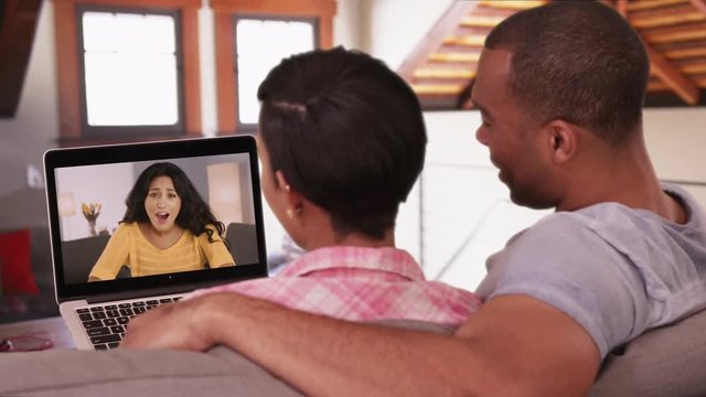 An African American man and woman video chat with their white friend