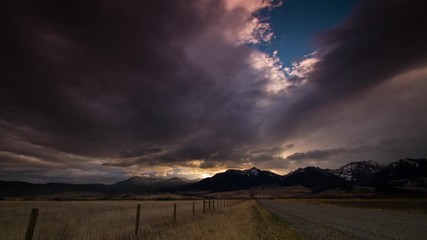 Absaroka mountains at sunrise over dirt road in Montana
